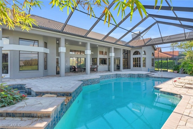 view of pool with a lanai and a patio