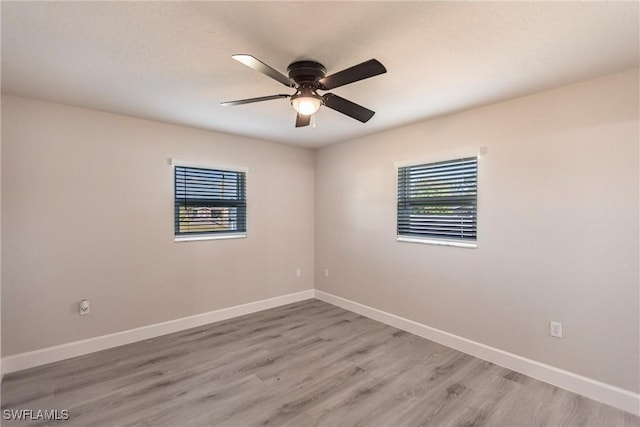 empty room with ceiling fan and light wood-type flooring