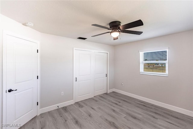 unfurnished bedroom with a closet, ceiling fan, and light hardwood / wood-style flooring