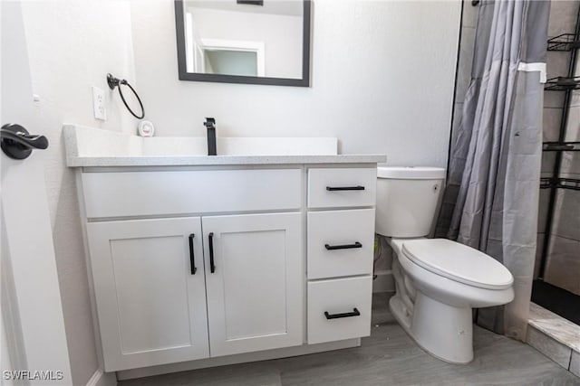 bathroom featuring vanity, wood-type flooring, toilet, and a shower with shower curtain