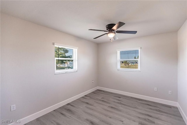 spare room featuring hardwood / wood-style flooring and ceiling fan