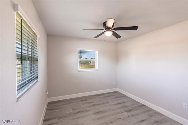 spare room with ceiling fan and light hardwood / wood-style floors