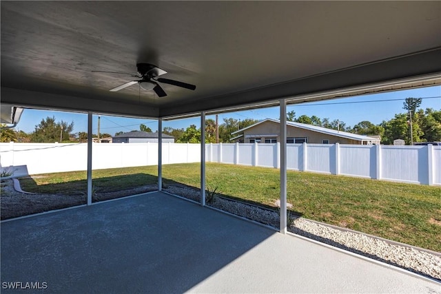 unfurnished sunroom featuring ceiling fan