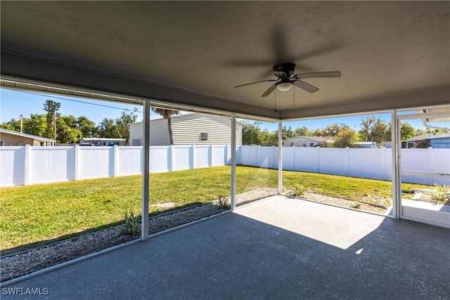 unfurnished sunroom with plenty of natural light and ceiling fan