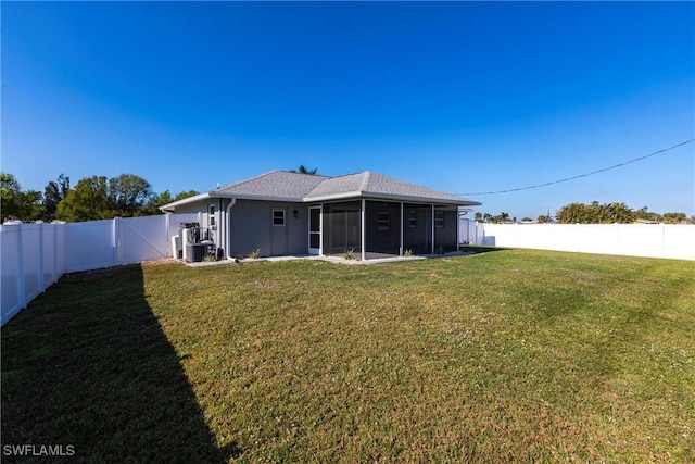 back of house featuring a sunroom and a yard