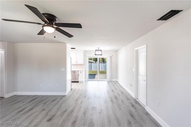 unfurnished living room featuring ceiling fan and light hardwood / wood-style flooring