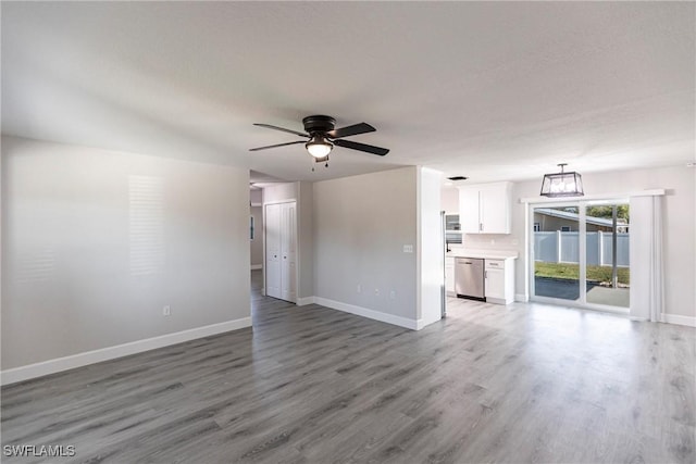 unfurnished living room with hardwood / wood-style flooring and ceiling fan