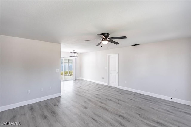 spare room featuring a textured ceiling, light hardwood / wood-style flooring, and ceiling fan