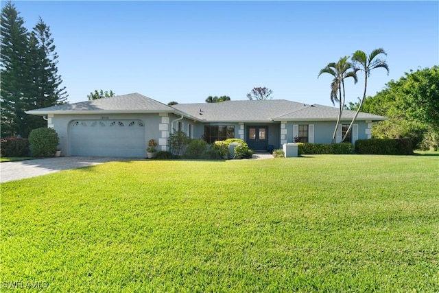 ranch-style home featuring a garage and a front yard