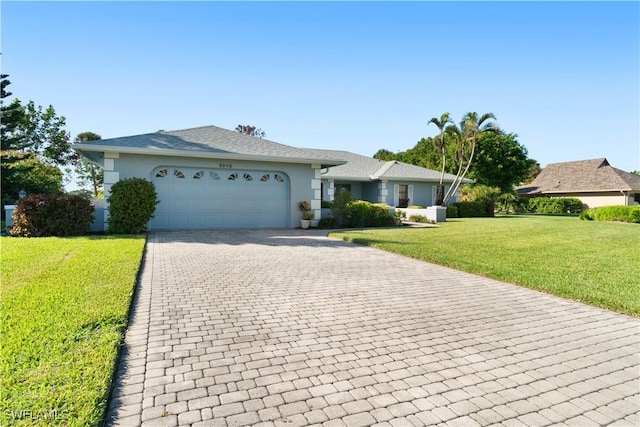 ranch-style house with a garage and a front lawn