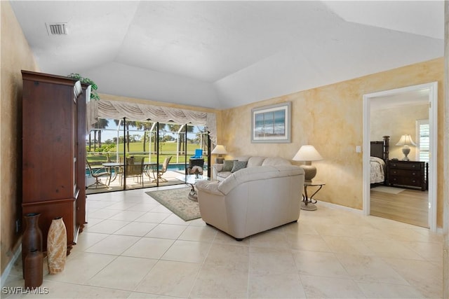 living room with lofted ceiling and light tile patterned floors