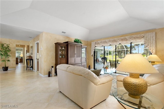 living room featuring vaulted ceiling