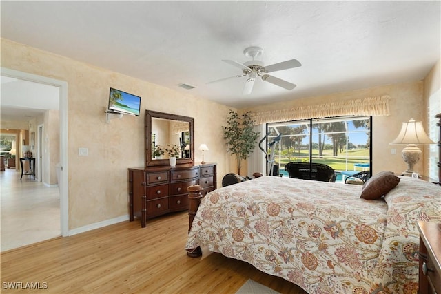 bedroom with light hardwood / wood-style flooring, access to outside, and ceiling fan