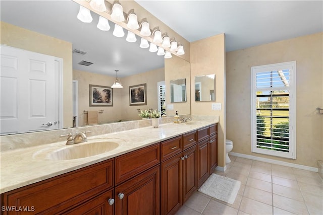 bathroom featuring vanity, tile patterned floors, and toilet