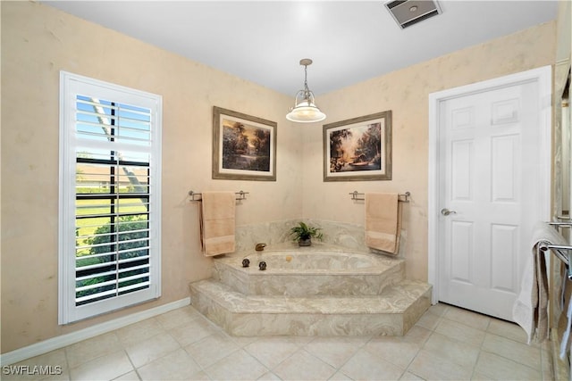 bathroom with tile patterned floors and tiled bath