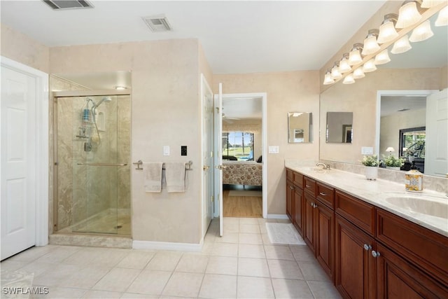 bathroom featuring tile patterned flooring, vanity, and an enclosed shower