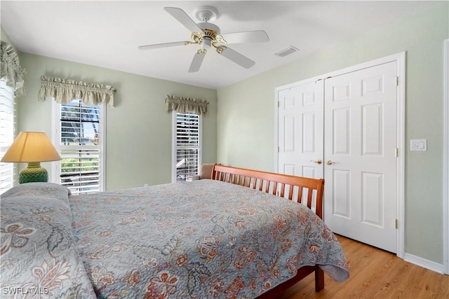 bedroom with ceiling fan, a closet, and light hardwood / wood-style flooring