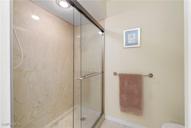 bathroom featuring a shower with shower door