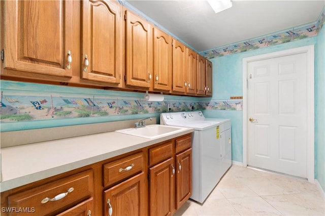 laundry room with sink, cabinets, independent washer and dryer, and light tile patterned flooring