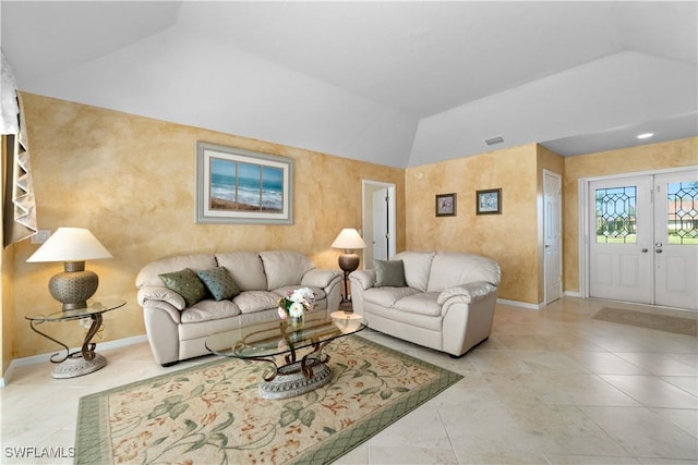 tiled living room with vaulted ceiling and french doors