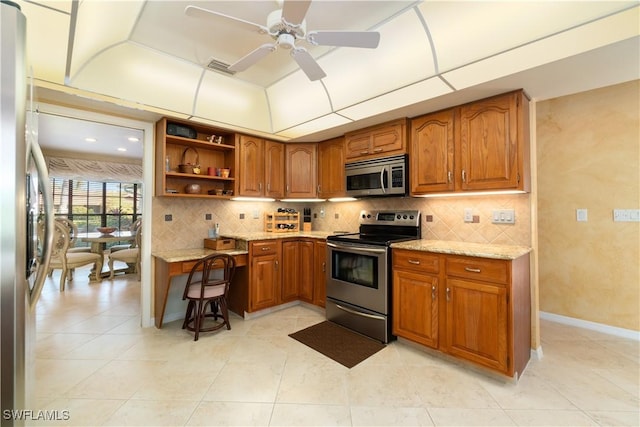 kitchen featuring light tile patterned flooring, tasteful backsplash, ceiling fan, stainless steel appliances, and light stone countertops