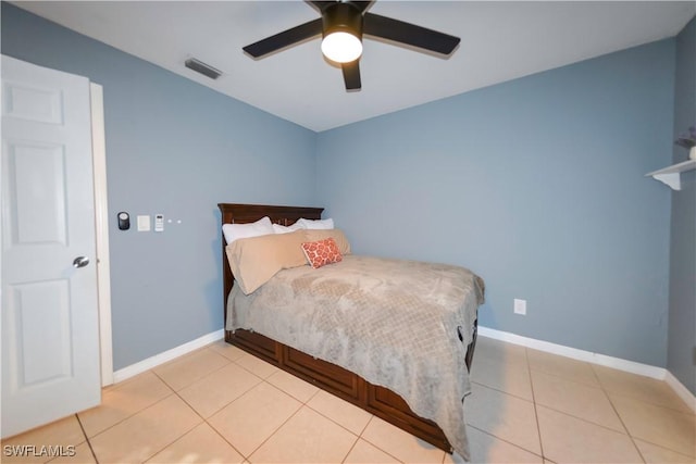 tiled bedroom with ceiling fan