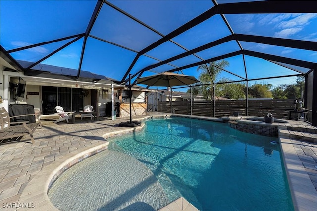 view of swimming pool featuring an in ground hot tub, a lanai, and a patio area