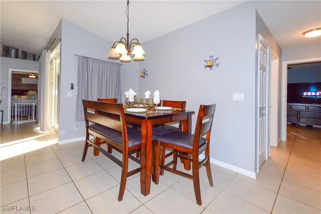 dining area featuring a chandelier and light tile patterned floors