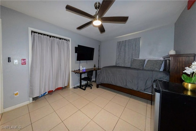 tiled bedroom featuring ceiling fan