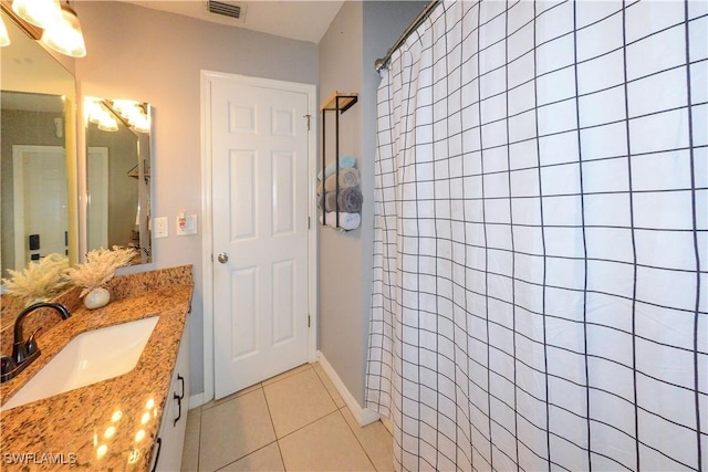 bathroom featuring vanity, tile patterned floors, and walk in shower