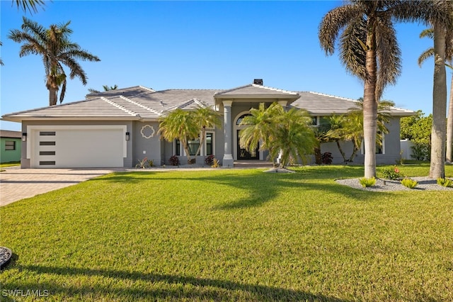 view of front of property featuring a garage and a front yard