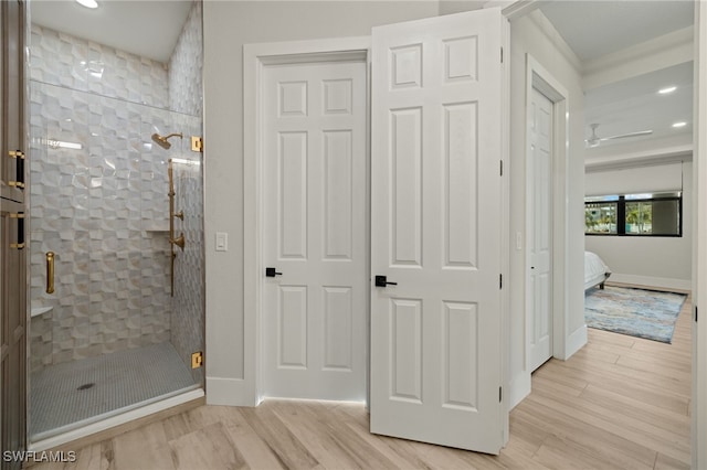 bathroom featuring an enclosed shower and wood-type flooring