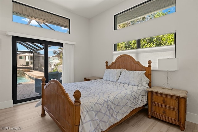 bedroom with light hardwood / wood-style flooring and access to outside