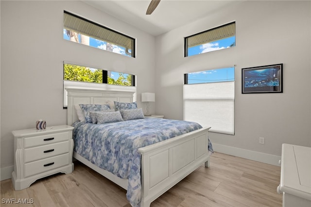 bedroom with ceiling fan and light wood-type flooring