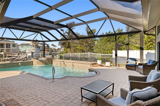 view of pool featuring a jacuzzi, a patio, pool water feature, and glass enclosure