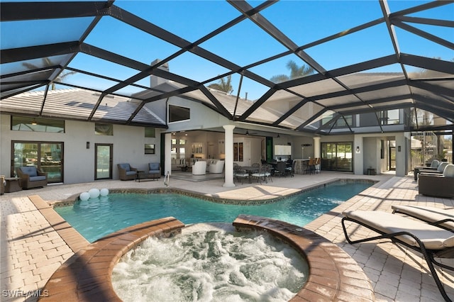 view of swimming pool featuring a patio area, outdoor lounge area, a lanai, an outdoor bar, and an in ground hot tub