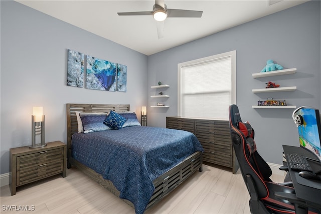 bedroom with ceiling fan and light hardwood / wood-style flooring