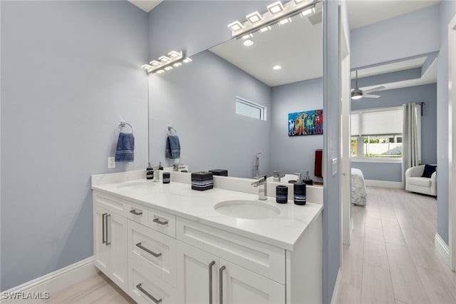 bathroom with hardwood / wood-style flooring, vanity, and ceiling fan