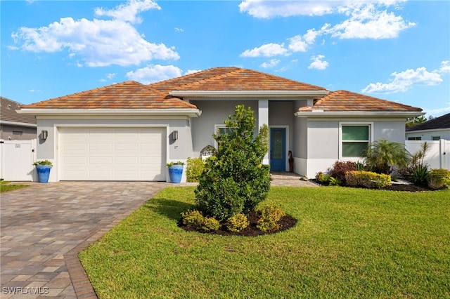 view of front facade featuring a garage and a front lawn