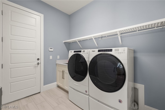 laundry area featuring cabinets and washer and dryer