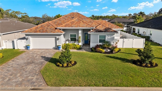 view of front of home featuring an attached garage, a gate, decorative driveway, and a front yard