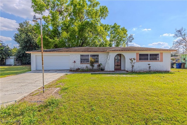 ranch-style home featuring a garage and a front lawn