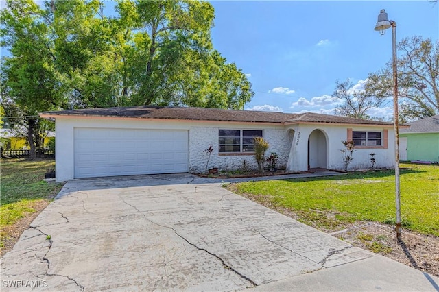 single story home featuring a garage and a front lawn