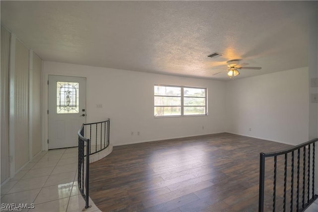 spare room featuring ceiling fan, hardwood / wood-style floors, and a textured ceiling