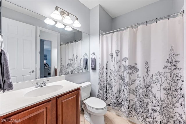 bathroom featuring vanity, tile patterned floors, and toilet