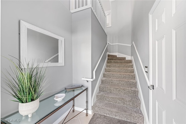 staircase featuring tile patterned floors