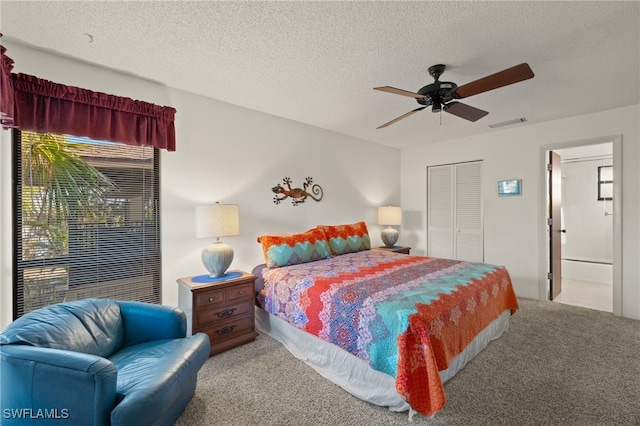 carpeted bedroom featuring a textured ceiling, ceiling fan, and a closet