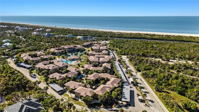 birds eye view of property with a water view and a view of the beach