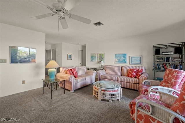 carpeted living room with ceiling fan and a textured ceiling