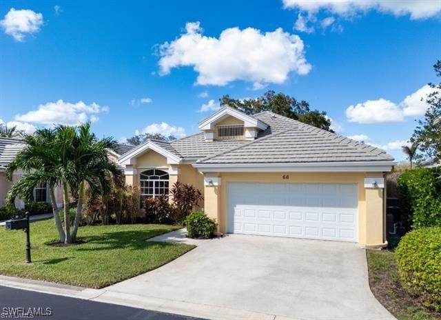 view of front of home with a garage and a front lawn